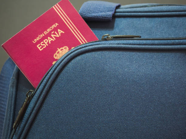 istock Spanish passport in blue suitcase. Travel concept 1347101466