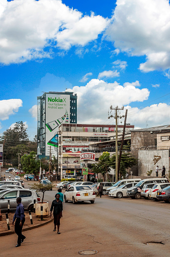 NAIROBI, KENYA - MAY 2014.Street scene in Nairobi. Cars and people in street. In background there are buildings, shops and advertising billboards.