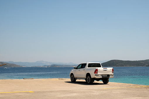 Trogir, Croatia. August 13, 2021. Modern white Toyota 4x4 hitlux barked at waterfront