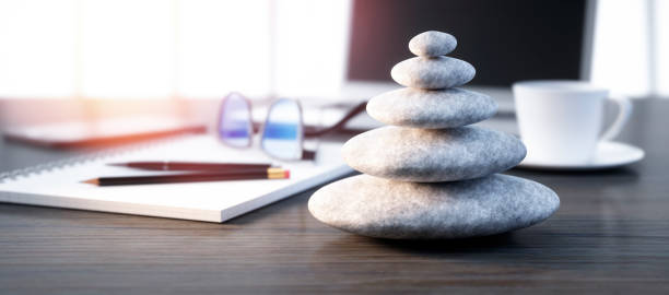Stack of pebbles on a workplace desktop Stack of white  pebbles on a workplace desktop - 3D illustration life balance photos stock pictures, royalty-free photos & images
