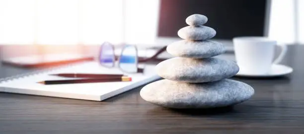 Stack of white  pebbles on a workplace desktop - 3D illustration