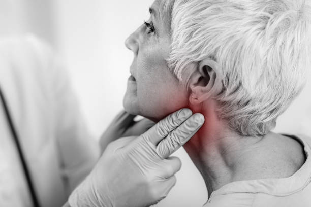 Thyroid Gland Control. Endocrinology Doctor Examining Senior Woman at Clinic. Thyroid gland control. Endocrinology doctor examining senior woman at a clinic. thyroid disease stock pictures, royalty-free photos & images