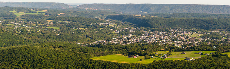 Aerial view of the rural neighborhood with a remote view of the town of Jim Thorpe in the backdrop, Carbon County, Poconos region, Pennsylvania, USA.