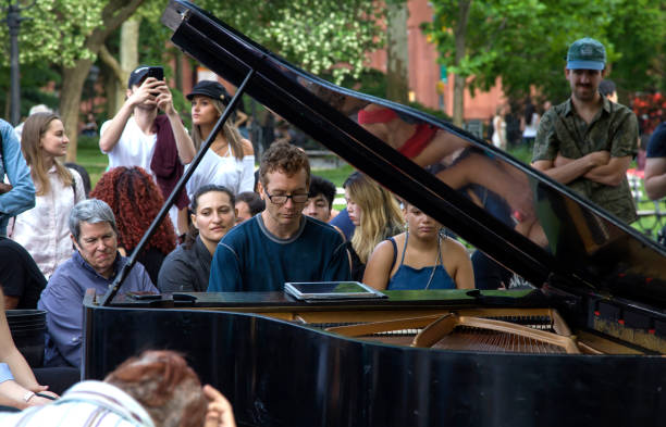 Piano man plays music in Washington Square Park NYC stock photo