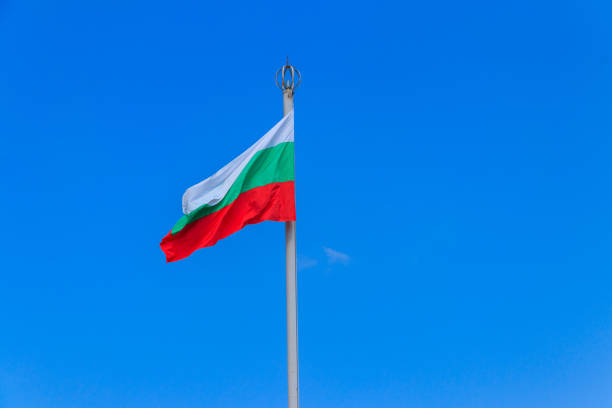 istock Waving flag of Bulgaria against blue sky 1347112182
