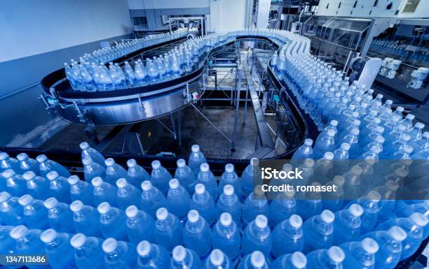 Conveyor Belt With Bottles Of Drinking Water At A Modern Beverage Plant Stock Photo - Download Image Now