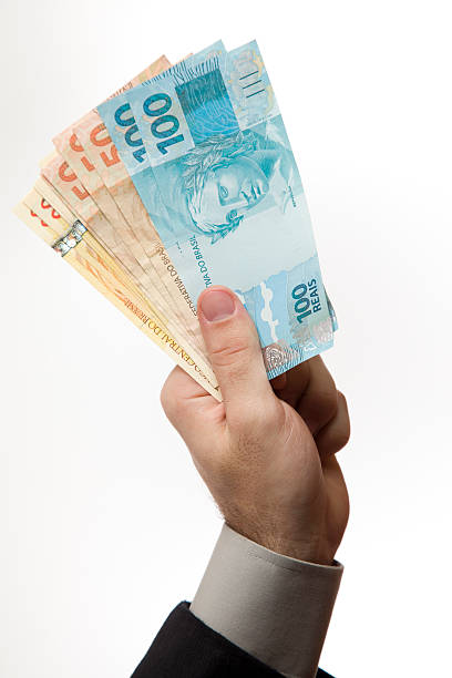 Hand holding a Brazilian money stock photo