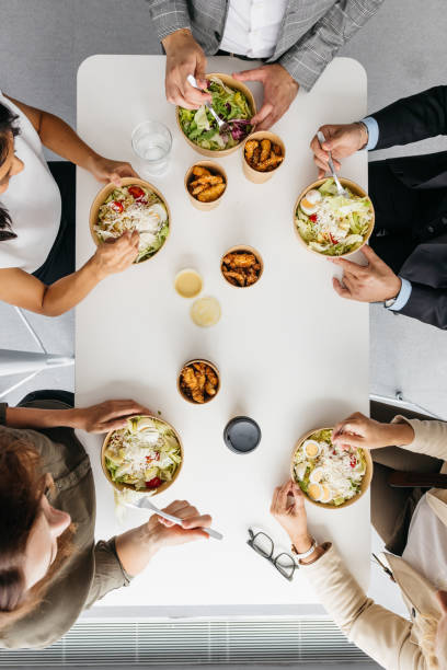 istock High-angle shot of co-workers enjoying takeaway lunch in an office 1347117583