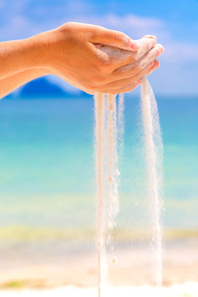 istock Sand falling through woman hands 1347118674