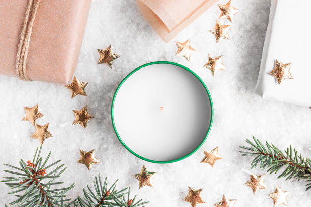 istock Christmas decorations on a snowy background with ice pieces close-up top view. Preparing for the New Year, gift wrapping, festive composition with candles. 1347118902