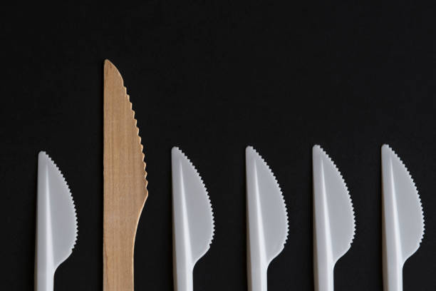istock Wooden and plastic disposable knifes on black background 1347122761