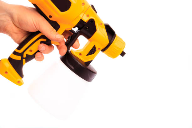 istock paint gun holding by mans hand isolated on white background 1347125386