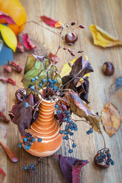 istock Picturesque still life, dry tree branches in vase. Autumn bouquet. Fall composition 1347127706