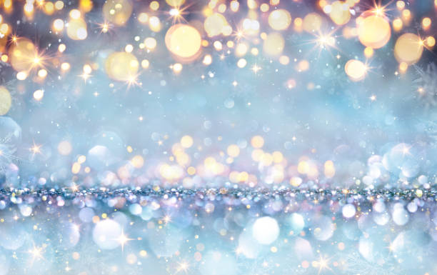 istock Abstract Magic Christmas Background - Shiny Golden Lights On Silver Blue Glitter With Snowflakes And Stars 1347129942