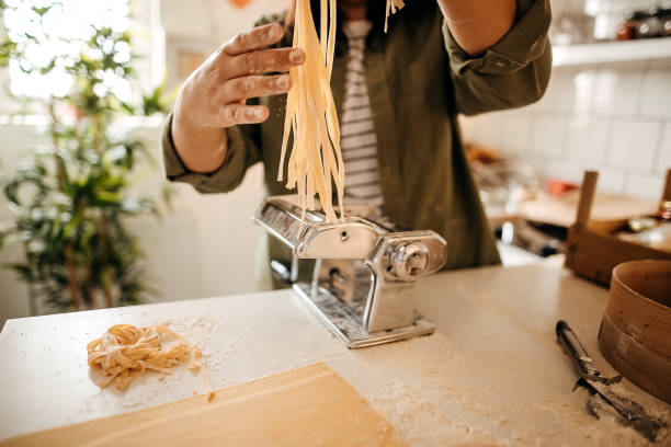 istock Young woman making homemade pasta in the kitchen 1347130959