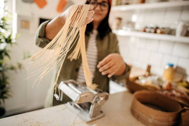 istock Young woman making homemade pasta in the kitchen 1347131033