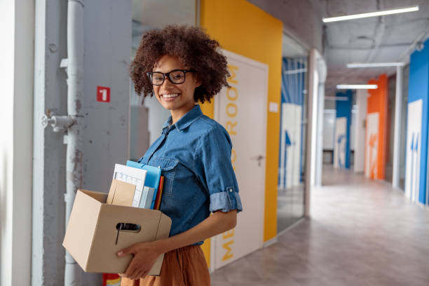 istock Smiling woman moving down the hallway in the office 1347138400