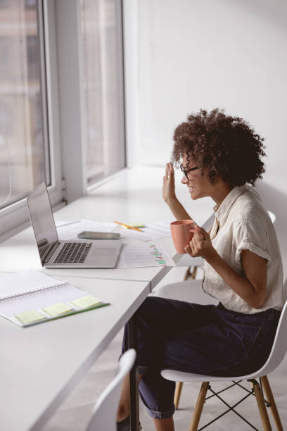 istock Happy Afro American lady waving hand during video conference 1347138469