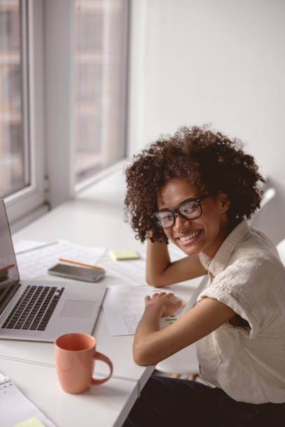 istock Happy Afro American woman working with documents 1347138474