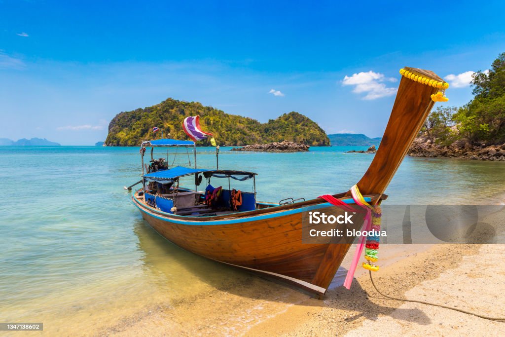 Thai traditional longtail boat Thai traditional wooden longtail boat at tropical beach in Thailand Ko Muk Stock Photo