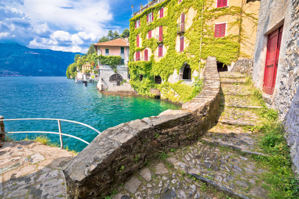 Town of Nesso historic stone bridge and scenic lakefront view, Como Lake Town of Nesso historic stone bridge and scenic lakefront view, Como Lake, Lombardy region of Italy lake como stock pictures, royalty-free photos & images