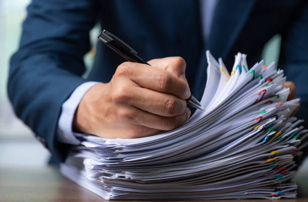 istock Businessman signing document after reading the agreement in office, hand writing. 1347139476