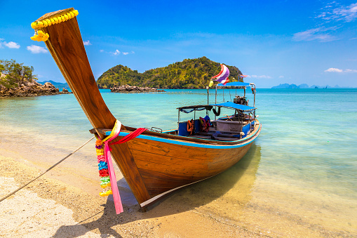 Thai traditional wooden longtail boat at tropical beach in Thailand