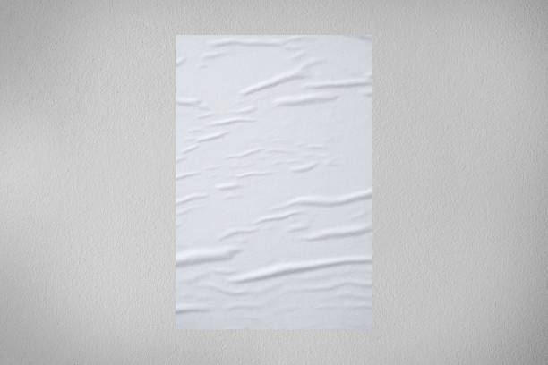 istock Blank white wheatpaste glued paper poster mockup on concrete wall background 1347145531