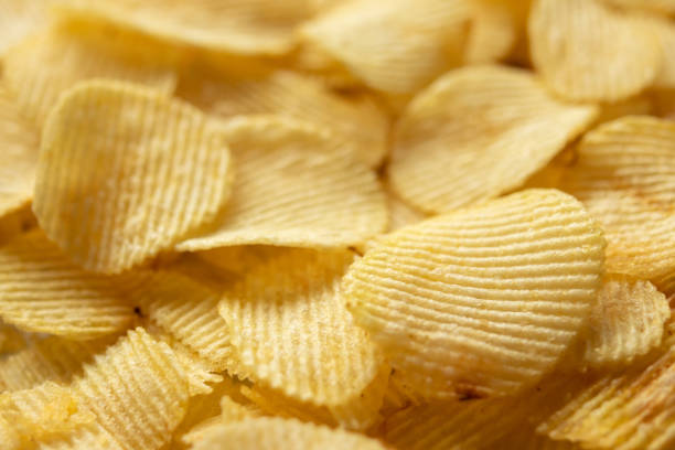 istock crispy golden potato chips snack texture background 1347145540