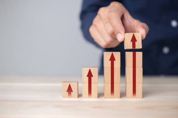 istock Growth graph and arrows ladder career path for business growth success process concept.Hand arranging wood block stacking as step stair with arrow up. 1347150360
