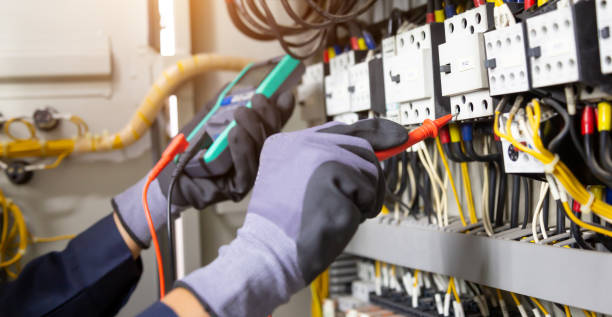 istock Electrician engineer tests electrical installations and wires on relay protection system. Adjustment of scheme of automation and control of electrical equipment. 1347150397