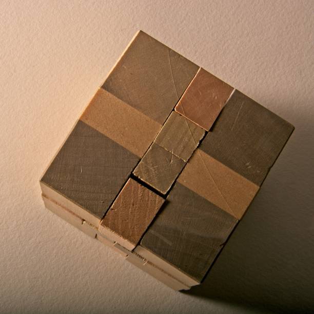 istock Three dimensional wooden puzzle block on textured paper surface 1347152021