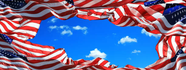 istock Large group of waving American flags frame over clear blue sky 1347153746