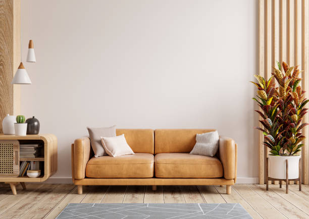 mockup della parete del soggiorno interno con divano in pelle e decorazioni su sfondo bianco. - armchair sofa leather brown foto e immagini stock