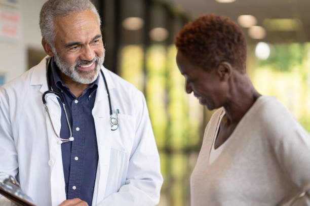 istock Doctor Talking with a Patient in the Hallway 1347157958