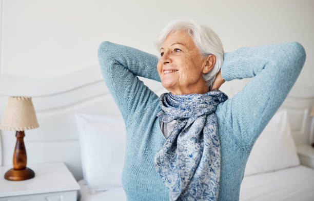 Shot of a senior woman relaxing on the bed at home stock photo