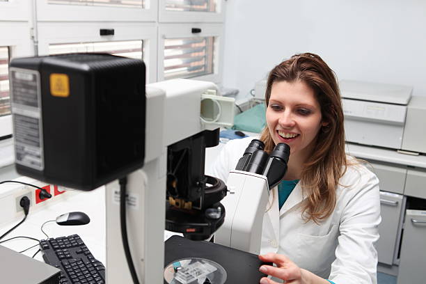 istock Young female researcher at the microscope 134715906