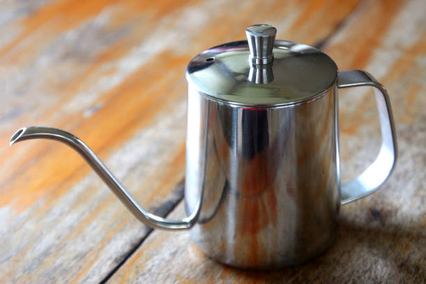 istock coffee drip kettle jug on wooden table 1347159179