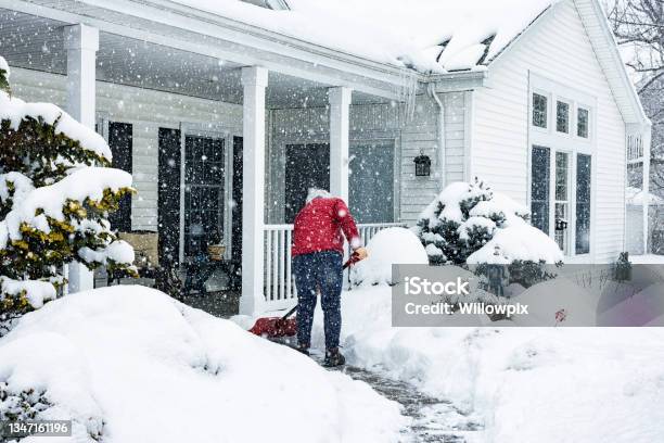 Red Jacket Woman Push Shoveling Winter Blizzard Snow Stock Photo - Download Image Now