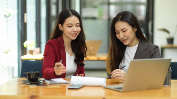 istock Two of business workers working, brainstorming and analysing competitor marketing strategy 1347161912
