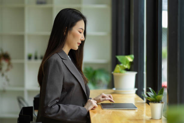 istock Successful and smart asian businesswoman working on her digital tablet computer. 1347161961