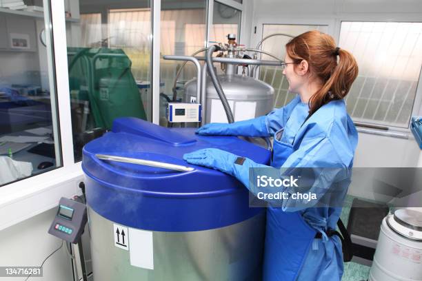 Container With Liquid Nitrogendoctor In Hazmat Suit At Work Stock Photo - Download Image Now