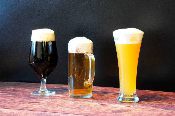 istock Three different glasses with three different beers are lined up on a brown wooden table. 1347164318