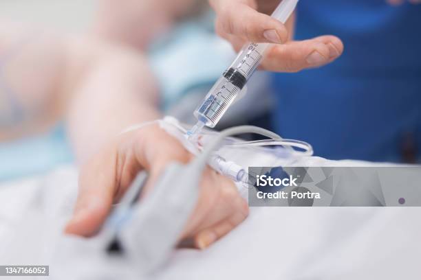 Cropped Hand Of Doctor Injecting Patient Stock Photo - Download Image Now - Anesthetic, IV Drip, Injecting