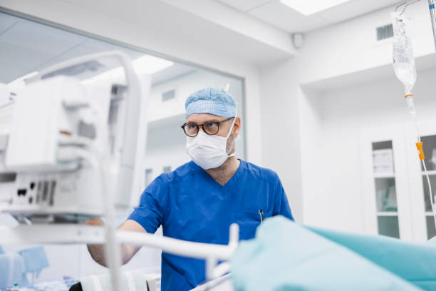 istock Male anesthetist working in operating room 1347166122