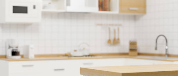 istock Wooden kitchen counter top on blurry modern white minimalist kitchen room interior 1347166225