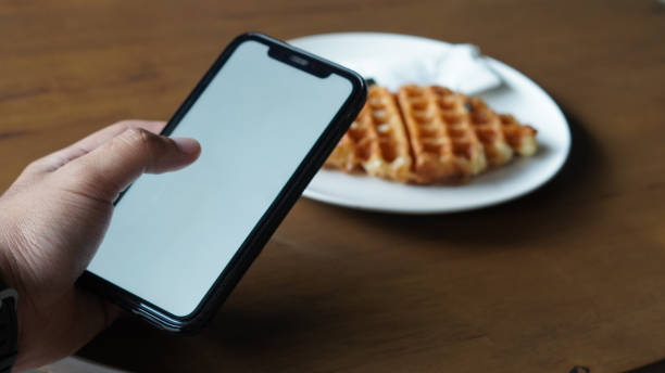 istock Mockup holding Smartphone with food in front 1347166996