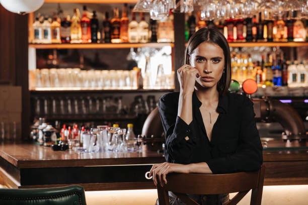 istock Glamorous young lady sitting at the bar 1347168325