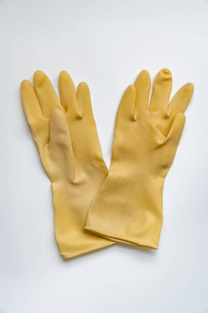 istock Yellow rubber gloves on white background 1347168933