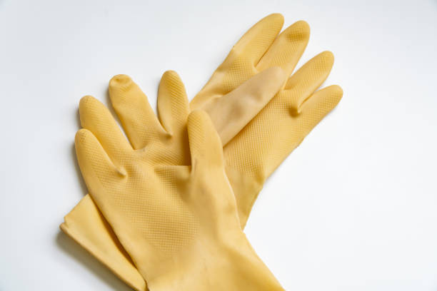 Yellow rubber gloves on white background